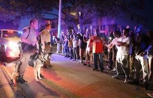 Ferguson police face off against protesters.  (Image courtesy of answercoalition.org)